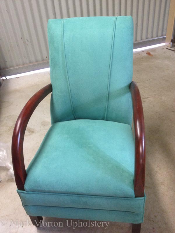 Teal armchair upholstering finished
